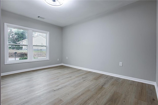 spare room with light hardwood / wood-style floors