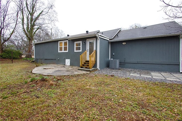 back of property featuring a lawn, a patio, and central air condition unit