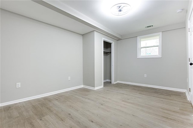 unfurnished bedroom with light hardwood / wood-style floors and a closet