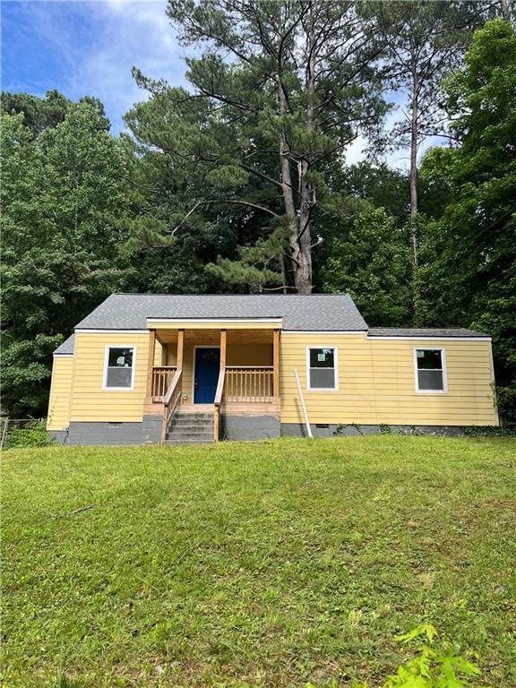 451 Collier Ridge Dr NW, Atlanta, GA 30318 - manufactured / mobile home featuring crawl space, a front yard, covered porch, and roof with shingles