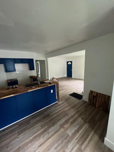 451 Collier Ridge Dr NW, Atlanta, GA 30318 - kitchen featuring blue cabinetry, wood finished floors, and butcher block countertops