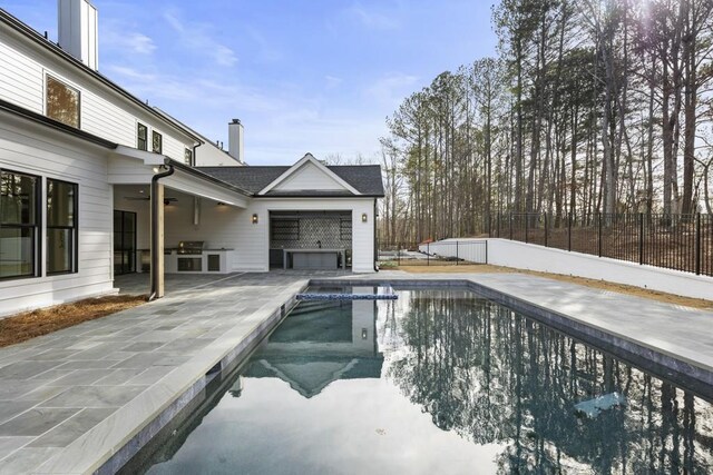 view of swimming pool with grilling area, ceiling fan, and a patio