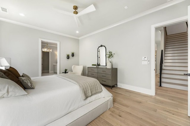 bedroom with ensuite bathroom, light wood-type flooring, ornamental molding, and ceiling fan with notable chandelier