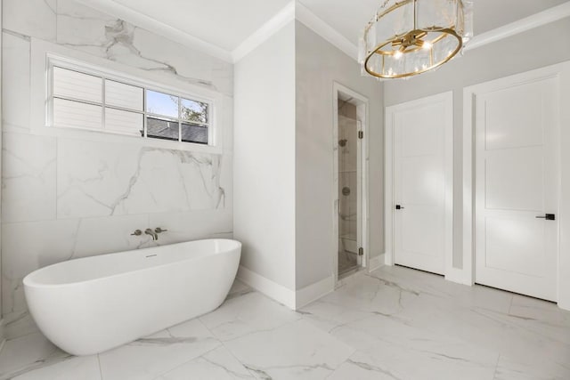 bathroom featuring separate shower and tub, ornamental molding, and a chandelier