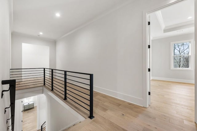 staircase featuring hardwood / wood-style flooring, crown molding, and a tray ceiling