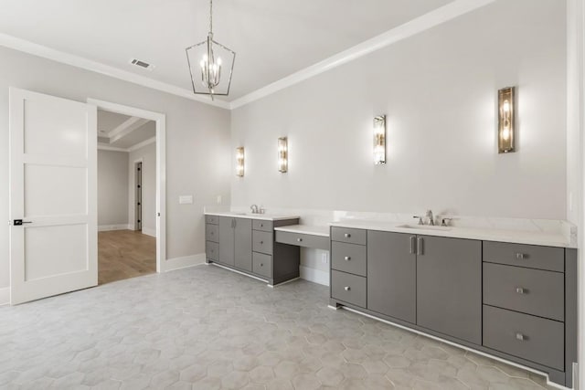 bathroom featuring ornamental molding, vanity, and an inviting chandelier