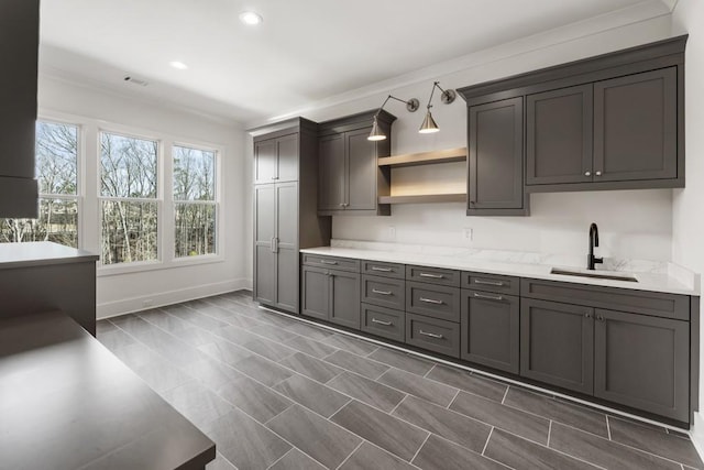 kitchen with sink and light stone countertops