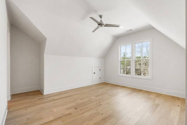 additional living space with light hardwood / wood-style flooring, ceiling fan, and vaulted ceiling