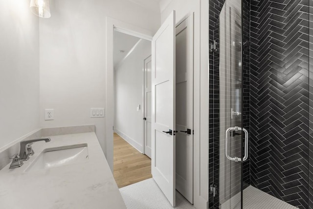 bathroom with vanity, wood-type flooring, and walk in shower