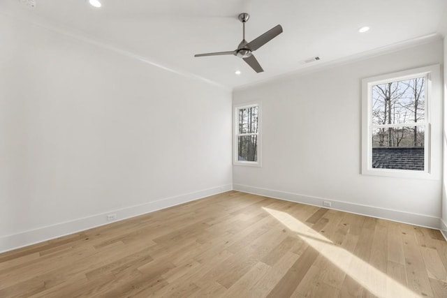 unfurnished room featuring ceiling fan, plenty of natural light, crown molding, and light hardwood / wood-style floors