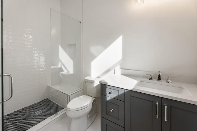 bathroom with vanity, toilet, and walk in shower