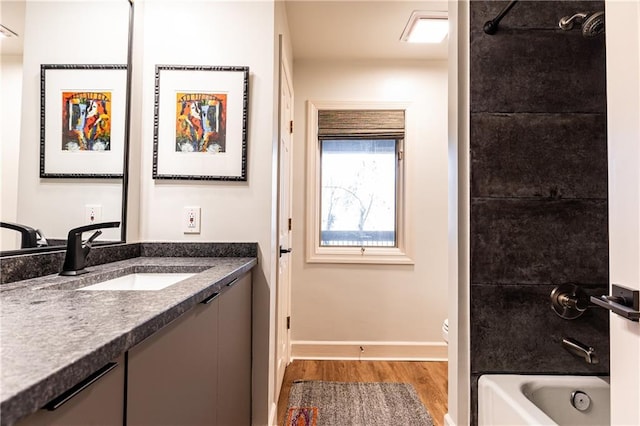 bathroom with vanity, hardwood / wood-style floors, and tub / shower combination