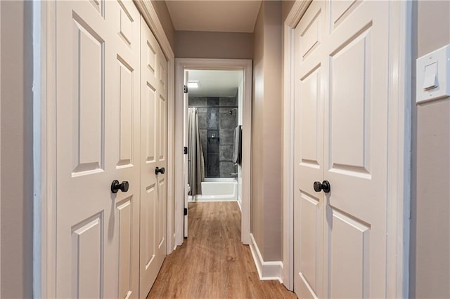 corridor with light hardwood / wood-style floors