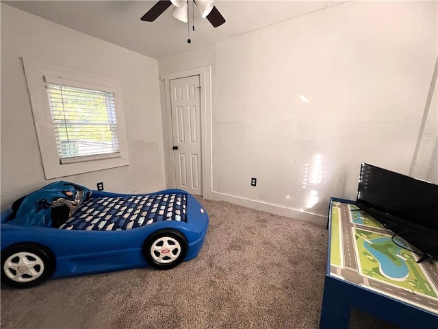 carpeted bedroom featuring baseboards and ceiling fan