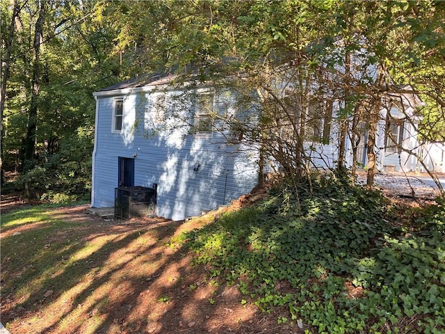 view of property exterior with a lawn