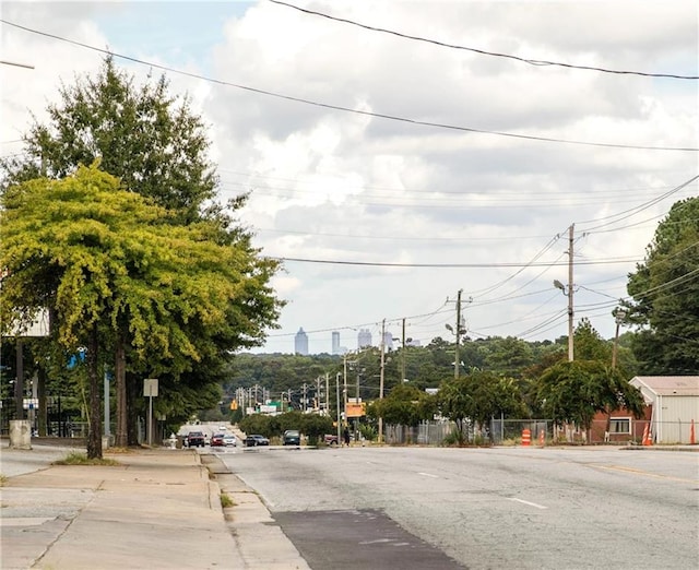 view of road with traffic signs and sidewalks