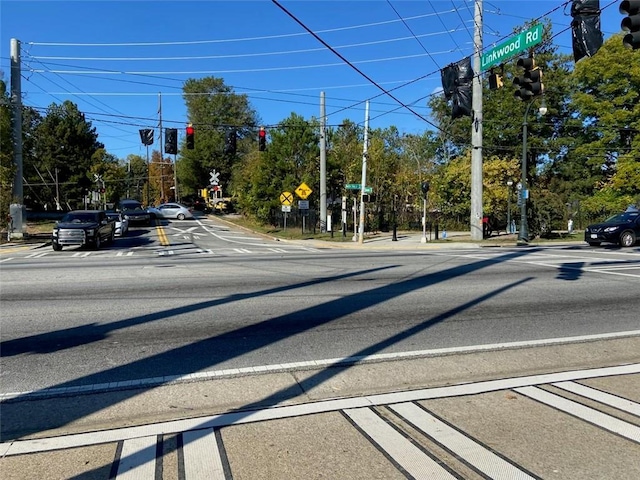 view of street with traffic signs, sidewalks, and traffic lights