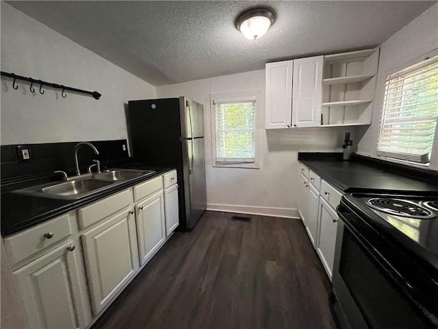 kitchen featuring dark countertops, a sink, black range with electric cooktop, and open shelves