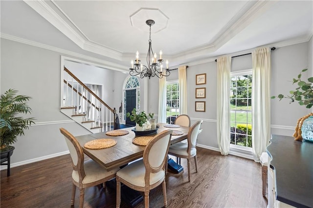 2500 Ashbourne Dr, Lawrenceville, GA 30043 - dining area with a chandelier, a tray ceiling, dark wood-type flooring, stairs, and ornamental molding