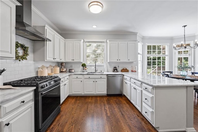 2500 Ashbourne Dr, Lawrenceville, GA 30043 - kitchen with gas stove, wall chimney range hood, stainless steel dishwasher, a peninsula, and healthy amount of natural light