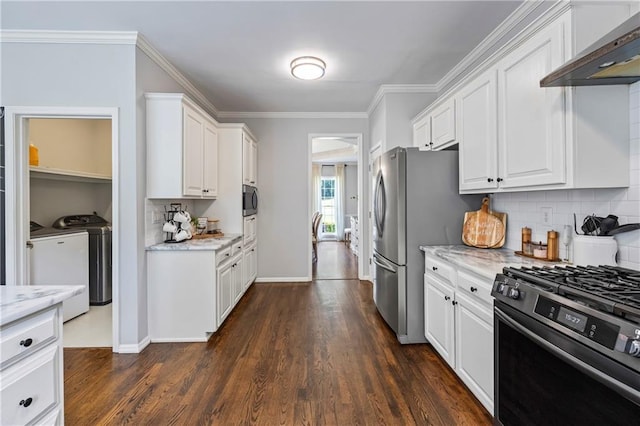 2500 Ashbourne Dr, Lawrenceville, GA 30043 - kitchen featuring washer and dryer, appliances with stainless steel finishes, wall chimney range hood, white cabinetry, and crown molding
