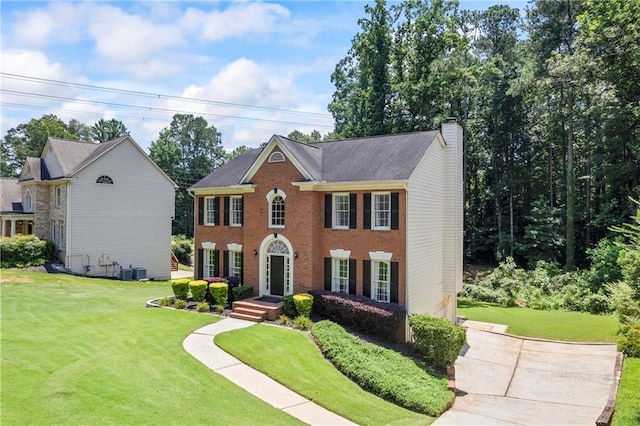 2500 Ashbourne Dr, Lawrenceville, GA 30043 - view of front of home featuring a chimney, a front lawn, and brick siding