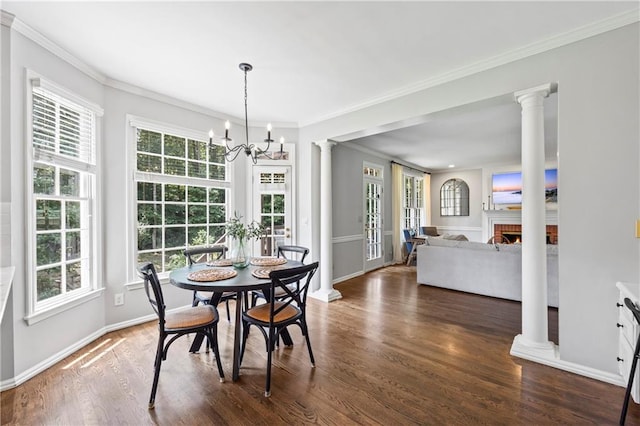 2500 Ashbourne Dr, Lawrenceville, GA 30043 - dining room with wood finished floors, decorative columns, a chandelier, and ornamental molding
