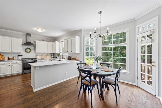 2500 Ashbourne Dr, Lawrenceville, GA 30043 - dining space with a chandelier, dark wood-style flooring, and crown molding