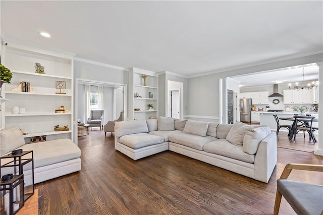 2500 Ashbourne Dr, Lawrenceville, GA 30043 - living area with crown molding, dark wood-style flooring, built in features, and a chandelier