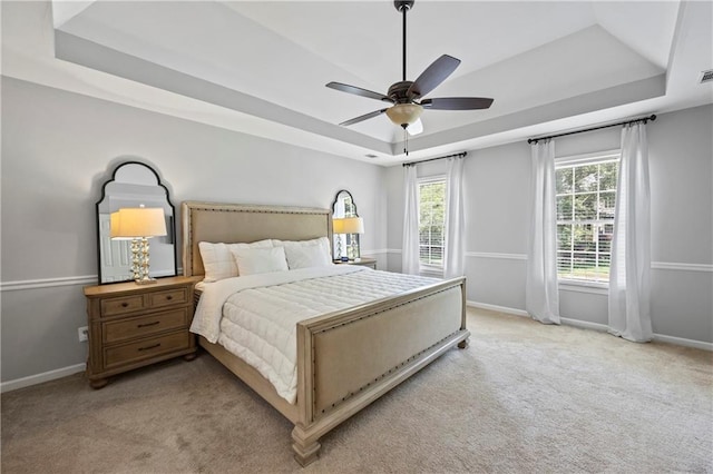 2500 Ashbourne Dr, Lawrenceville, GA 30043 - bedroom featuring a tray ceiling, light colored carpet, and ceiling fan