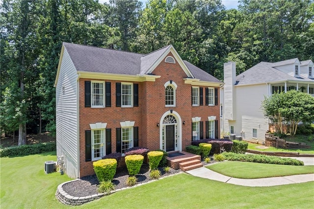 2500 Ashbourne Dr, Lawrenceville, GA 30043 - colonial-style house with a front lawn, brick siding, and roof with shingles