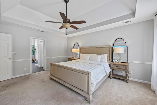 2500 Ashbourne Dr, Lawrenceville, GA 30043 - bedroom with a raised ceiling, carpet flooring, connected bathroom, and a ceiling fan