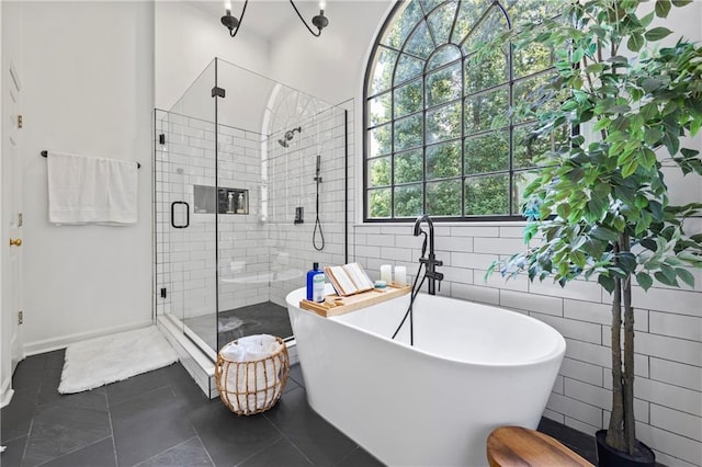 2500 Ashbourne Dr, Lawrenceville, GA 30043 - bathroom featuring a stall shower, a freestanding bath, tile walls, and tile patterned flooring