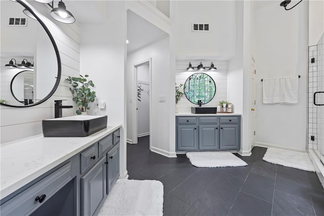 2500 Ashbourne Dr, Lawrenceville, GA 30043 - full bath featuring two vanities, a stall shower, tasteful backsplash, and tile patterned floors