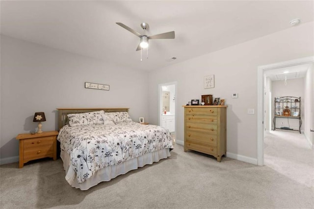 bedroom with light colored carpet, attic access, baseboards, and a ceiling fan