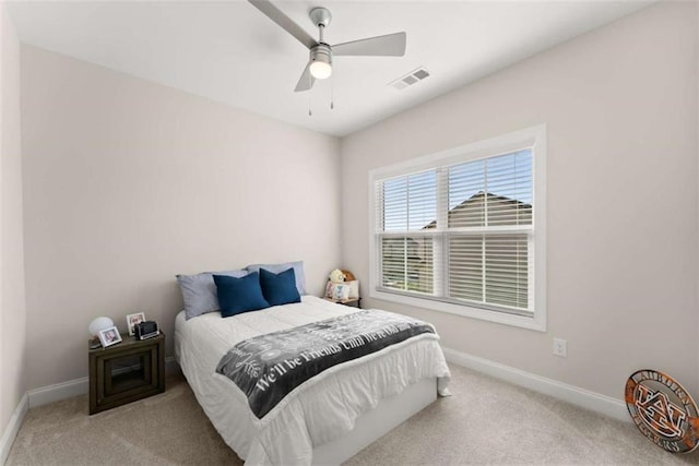 bedroom with baseboards, carpet flooring, visible vents, and a ceiling fan