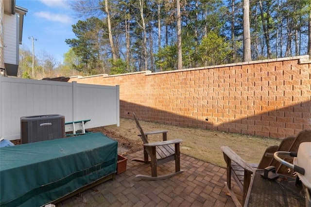 view of patio / terrace featuring cooling unit and a fenced backyard