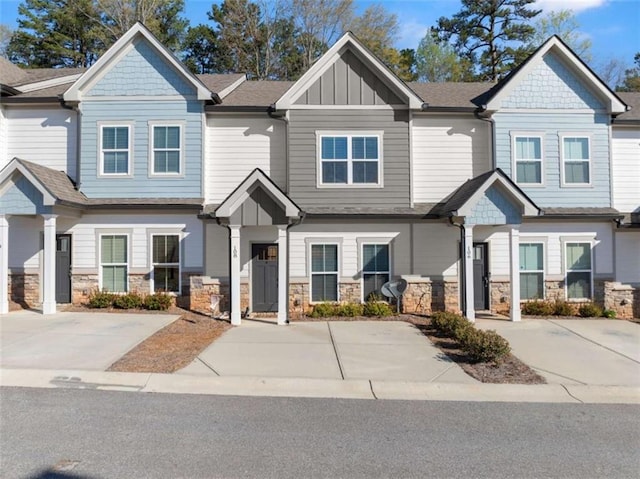 multi unit property featuring stone siding and board and batten siding
