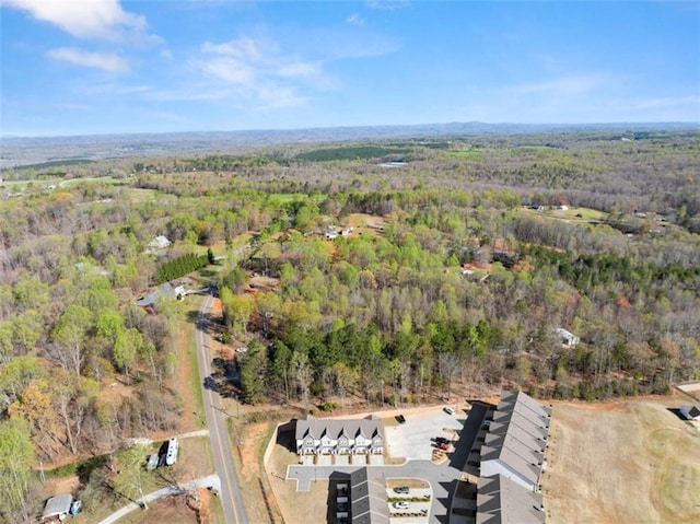 birds eye view of property with a wooded view