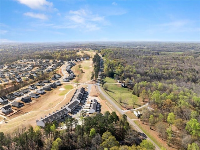 birds eye view of property featuring a forest view