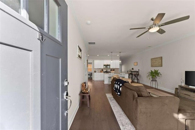 living room featuring a ceiling fan, baseboards, visible vents, and dark wood-type flooring