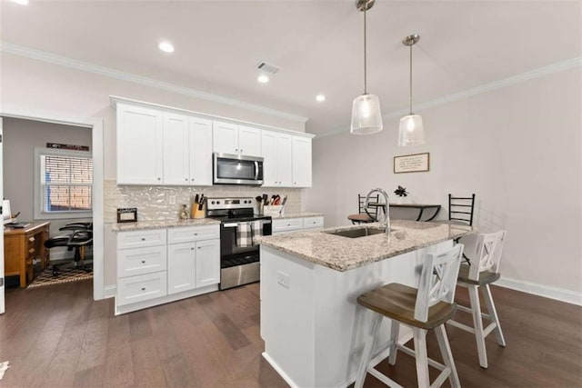 kitchen with a sink, stainless steel appliances, ornamental molding, visible vents, and white cabinetry