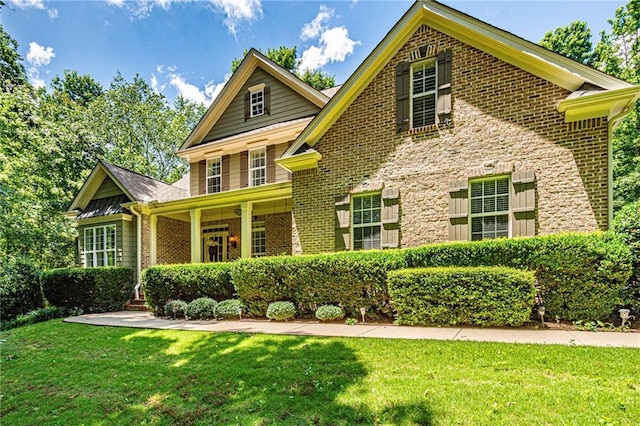 6369 Timber Creek Trl, Dahlonega, GA 30533 - traditional-style home with brick siding, a front lawn, and a porch