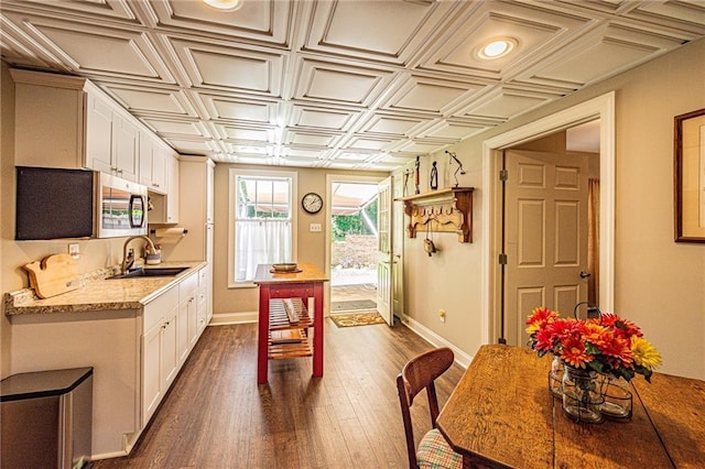 6369 Timber Creek Trl, Dahlonega, GA 30533 - kitchen featuring an ornate ceiling, white cabinets, dark wood-type flooring, and stainless steel microwave
