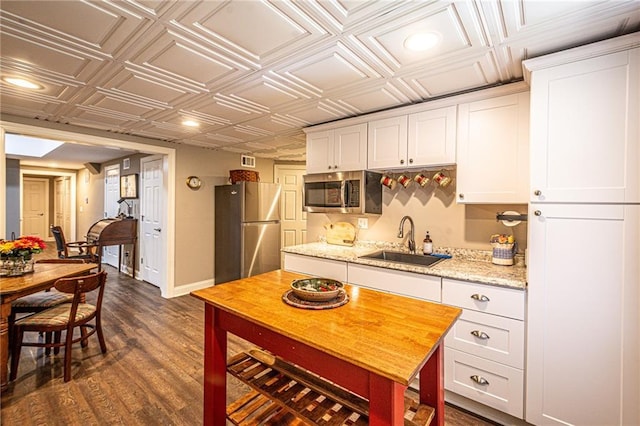 6369 Timber Creek Trl, Dahlonega, GA 30533 - kitchen with appliances with stainless steel finishes, an ornate ceiling, white cabinets, dark wood-style flooring, and recessed lighting