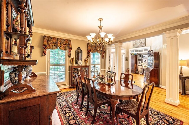 6369 Timber Creek Trl, Dahlonega, GA 30533 - dining space featuring ornate columns, a chandelier, crown molding, and light wood-style floors