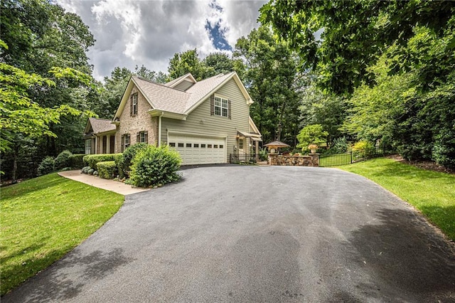 6369 Timber Creek Trl, Dahlonega, GA 30533 - view of front of house with asphalt driveway, an attached garage, view of scattered trees, and brick siding