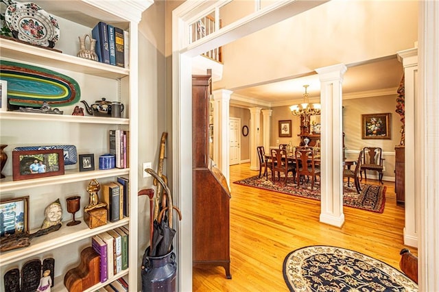 6369 Timber Creek Trl, Dahlonega, GA 30533 - entryway with ornate columns, light wood-type flooring, a chandelier, and crown molding