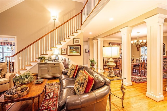 6369 Timber Creek Trl, Dahlonega, GA 30533 - living room with ornate columns, ornamental molding, a chandelier, light wood-style floors, and stairs