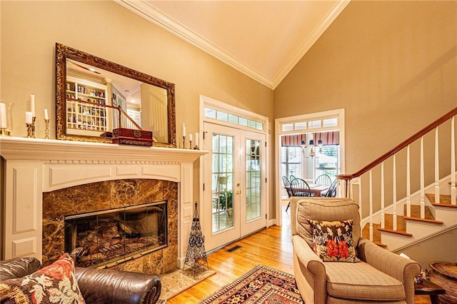 6369 Timber Creek Trl, Dahlonega, GA 30533 - living area featuring ornamental molding, stairway, wood finished floors, a high end fireplace, and high vaulted ceiling